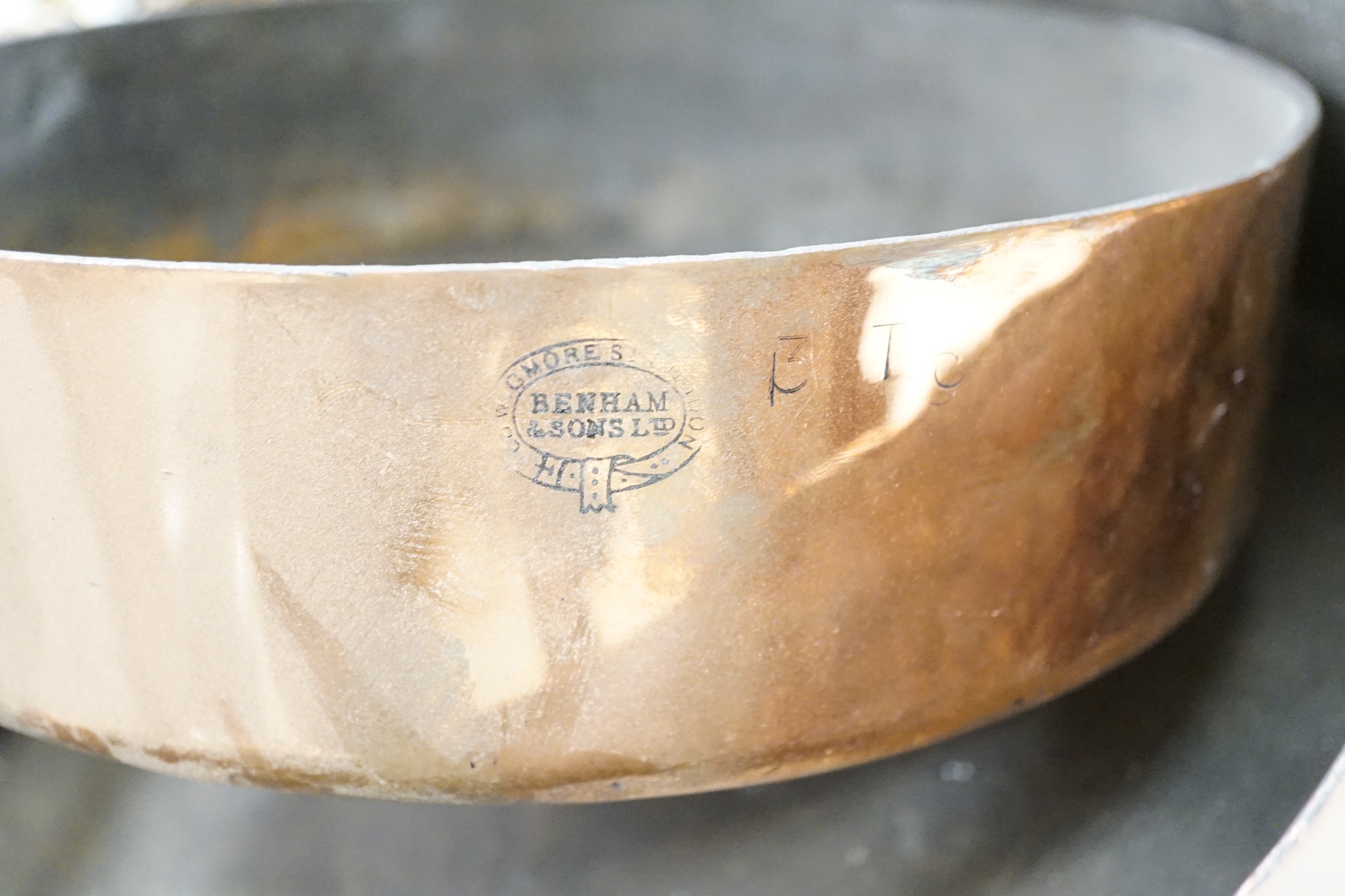Three copper pans, largest diameter 35cm